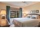 Comfortable bedroom featuring a queen-size bed, soothing colors, and a window with lush outdoor views at 1531 Clower Creek Dr # Ha245, Sarasota, FL 34231