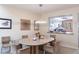 Dining room with modern lighting fixture that looks into the kitchen at 1531 Clower Creek Dr # Ha245, Sarasota, FL 34231