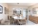 Dining room with modern lighting fixture that looks into the living room and kitchen at 1531 Clower Creek Dr # Ha245, Sarasota, FL 34231