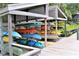 Outdoor kayak storage with variety of kayaks on racks along a wooden dock at 1531 Clower Creek Dr # Ha245, Sarasota, FL 34231