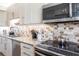 Bright kitchen with stainless steel appliances, stone backsplash, and granite countertops at 1531 Clower Creek Dr # Ha245, Sarasota, FL 34231