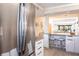 Kitchen with stainless steel refrigerator, breakfast bar, white cabinets and hardwood flooring at 1531 Clower Creek Dr # Ha245, Sarasota, FL 34231