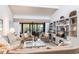 Comfortable living area with vaulted ceiling, built-ins, and sliding doors to outdoor lanai at 1531 Clower Creek Dr # Ha245, Sarasota, FL 34231