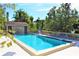 Outdoor pool with clear blue water, surrounded by lounge chairs and lush greenery at 1531 Clower Creek Dr # Ha245, Sarasota, FL 34231