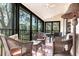 Bright, airy sunroom with wicker furniture and scenic views of the surrounding landscape at 1531 Clower Creek Dr # Ha245, Sarasota, FL 34231