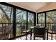 Enclosed sunroom featuring expansive windows and comfortable seating with peaceful outdoor view at 1531 Clower Creek Dr # Ha245, Sarasota, FL 34231