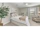 Cozy bedroom featuring a white bed with starfish pillows, a sitting chair, and a decorative plant at 16438 Slate Pl, Lakewood Ranch, FL 34211