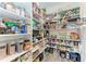 Well-stocked walk-in pantry, featuring ample shelving and storage for food, appliances and kitchen supplies at 16438 Slate Pl, Lakewood Ranch, FL 34211