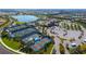 Aerial view of the tennis courts, clubhouse, pool, and lake in the Del Webb community of Lakewood Ranch at 17026 Loudon Pl, Bradenton, FL 34202