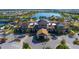 Aerial view of an upscale community clubhouse, showcasing its architectural details, lush landscaping, and resort-style pool at 17026 Loudon Pl, Bradenton, FL 34202