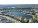 Aerial view of a residential area showcasing a lakefront property surrounded by beautiful landscaping and neighboring homes at 17026 Loudon Pl, Bradenton, FL 34202