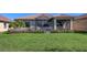 Expansive backyard featuring lush green grass and an inviting screened-in lanai for outdoor enjoyment at 17026 Loudon Pl, Bradenton, FL 34202