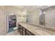 Elegant bathroom featuring dual sinks, granite countertops, and a walk-in shower at 17026 Loudon Pl, Bradenton, FL 34202