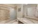 Well lit bathroom with granite vanity, combination tub/shower and tan tile at 17026 Loudon Pl, Bradenton, FL 34202