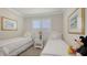 Charming bedroom featuring twin beds, neutral decor, and bright natural light from shuttered window at 17026 Loudon Pl, Bradenton, FL 34202