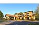 Exterior of the Del Webb clubhouse showcasing a covered entrance and lush landscaping at 17026 Loudon Pl, Bradenton, FL 34202