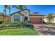 Attractive single-Gathering home showcasing a brick driveway, well-manicured lawn, and tiled roof at 17026 Loudon Pl, Bradenton, FL 34202