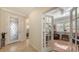 Home foyer with decorative glass front door, office with french doors, and tile flooring at 17026 Loudon Pl, Bradenton, FL 34202