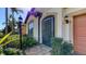 Front door entrance with dark trim, charming light fixture, and neatly manicured bushes at 17026 Loudon Pl, Bradenton, FL 34202