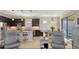 Open-concept kitchen featuring dark cabinets, a center island with seating, and stainless steel appliances, perfect for entertaining at 17026 Loudon Pl, Bradenton, FL 34202