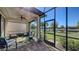 Relaxing screened lanai with comfortable seating and serene lake views, perfect for enjoying the outdoors in comfort at 17026 Loudon Pl, Bradenton, FL 34202