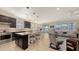 Open-concept kitchen and living room with sleek appliances, pendant lighting, and access to outdoor view at 17026 Loudon Pl, Bradenton, FL 34202