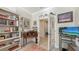Office featuring built-in bookcase, wood desk, natural light, and glass french doors at 17026 Loudon Pl, Bradenton, FL 34202