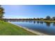 Scenic view of the tranquil pond with lush green landscaping along the shoreline at 17026 Loudon Pl, Bradenton, FL 34202