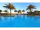 Resort-style pool with palm trees, lounge chairs, and landscaped surroundings at 17026 Loudon Pl, Bradenton, FL 34202