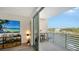Balcony with a view that shows a TV and entertainment center, with a partial view of the water at 1709 N Tamiami Trl # 408, Sarasota, FL 34234