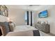 Well-lit bedroom with modern decor, neutral colors, and a view of the outdoors at 1709 N Tamiami Trl # 408, Sarasota, FL 34234