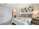 Cozy bedroom featuring modern art, soft textures, and an ensuite bath at 1709 N Tamiami Trl # 408, Sarasota, FL 34234