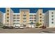 Exterior view of a modern condo building with multiple balconies and covered parking at 1709 N Tamiami Trl # 408, Sarasota, FL 34234