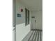 Hallway view of unit doors A 408 and A 409 with a window and shadow lines at 1709 N Tamiami Trl # 408, Sarasota, FL 34234