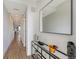 Bright hallway with wood floors, and a mirrored console table showcasing modern decor at 1709 N Tamiami Trl # 408, Sarasota, FL 34234