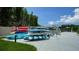 A selection of kayaks and paddle boards sits on a concrete deck with waterfront views at 1709 N Tamiami Trl # 408, Sarasota, FL 34234