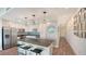 Bright kitchen with island and stainless appliances, adjacent to a hallway with photo gallery at 1709 N Tamiami Trl # 408, Sarasota, FL 34234