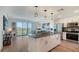 Modern kitchen featuring a large island with stainless steel appliances and balcony access at 1709 N Tamiami Trl # 408, Sarasota, FL 34234