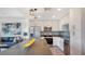 Open kitchen with stainless steel appliances and a large island flowing into the living area at 1709 N Tamiami Trl # 408, Sarasota, FL 34234