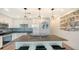 Well-lit kitchen with a large island, stainless steel appliances, and decorative tile backsplash at 1709 N Tamiami Trl # 408, Sarasota, FL 34234