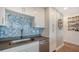 Modern kitchen with blue tile backsplash, stainless steel appliances and gray countertops at 1709 N Tamiami Trl # 408, Sarasota, FL 34234