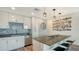 Modern kitchen featuring stainless steel appliances, a spacious island, and a stylish backsplash at 1709 N Tamiami Trl # 408, Sarasota, FL 34234