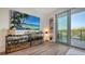 Stylish living room featuring a large flat screen TV and sliding glass doors leading to a balcony at 1709 N Tamiami Trl # 408, Sarasota, FL 34234