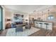 Modern open concept living room and kitchen with gray accents and island seating at 1709 N Tamiami Trl # 408, Sarasota, FL 34234