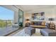 Beautiful living room with a gray sofa, modern art, and a sliding glass door to a large balcony at 1709 N Tamiami Trl # 408, Sarasota, FL 34234