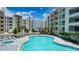 Inviting pool area with a large pool, hot tub, lounge chairs, and lush landscaping at 1709 N Tamiami Trl # 408, Sarasota, FL 34234