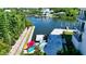 An aerial view captures the waterfront featuring a dock with kayaks and boats at 1709 N Tamiami Trl # 408, Sarasota, FL 34234