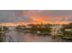 Stunning waterfront view at sunset with boats docked along the canal at 1709 N Tamiami Trl # 408, Sarasota, FL 34234