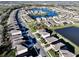 Aerial view of a community with a playground, lake, and landscaped greenery at 17119 Harvest Moon Way, Bradenton, FL 34211