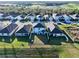 Aerial view of homes that back onto a tranquil pond with well-maintained lawns, and a community playground at 17119 Harvest Moon Way, Bradenton, FL 34211